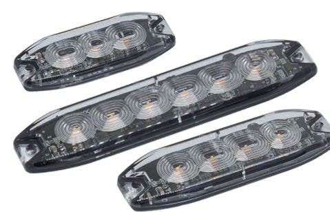 Three long rectangular LED light assemblies with smoked transparent housings and visible circular LED rings, shown on a plain white background.
